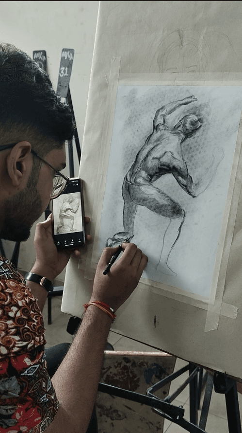 Woman working on a laptop computer at a table in a bright room.