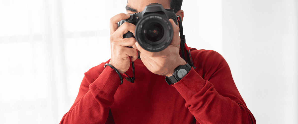 A person holding a professional camera for shooting commercial ad films  representing how commercial ad films on social media can boost sales.