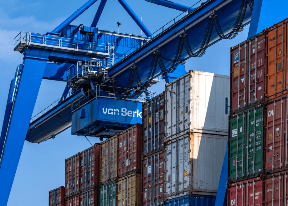 Crane placing a container on top of other containers