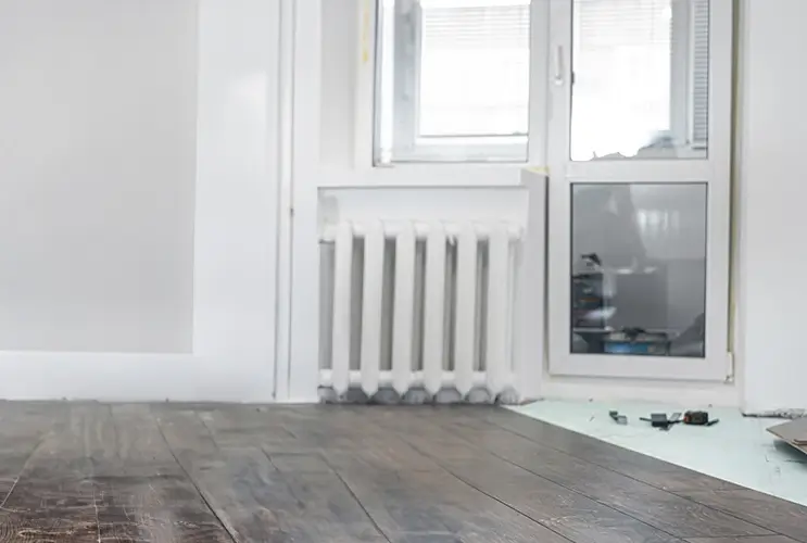 Worker installing hardwood flooring