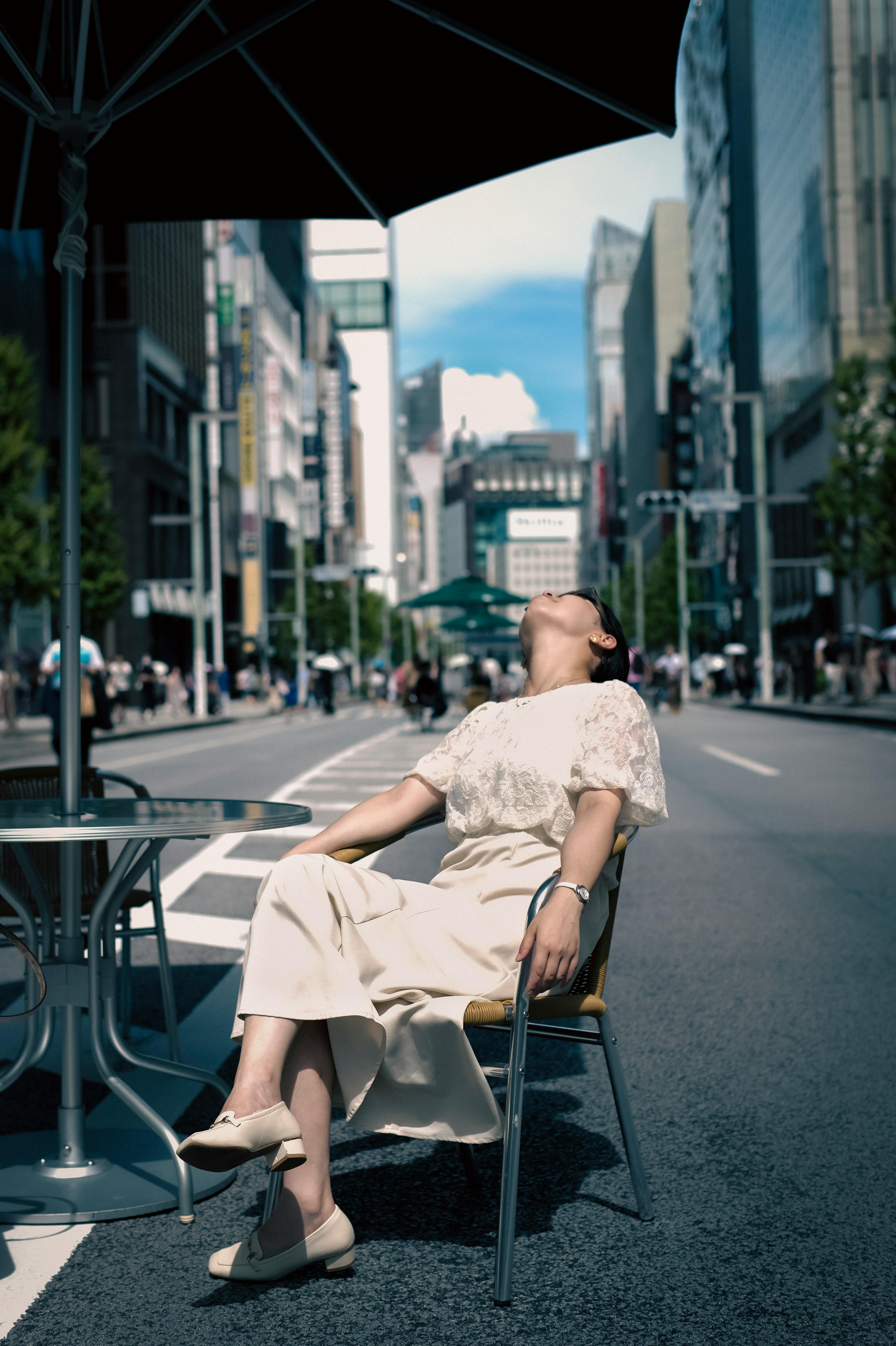 man sitting on the street in the summer in tokyo