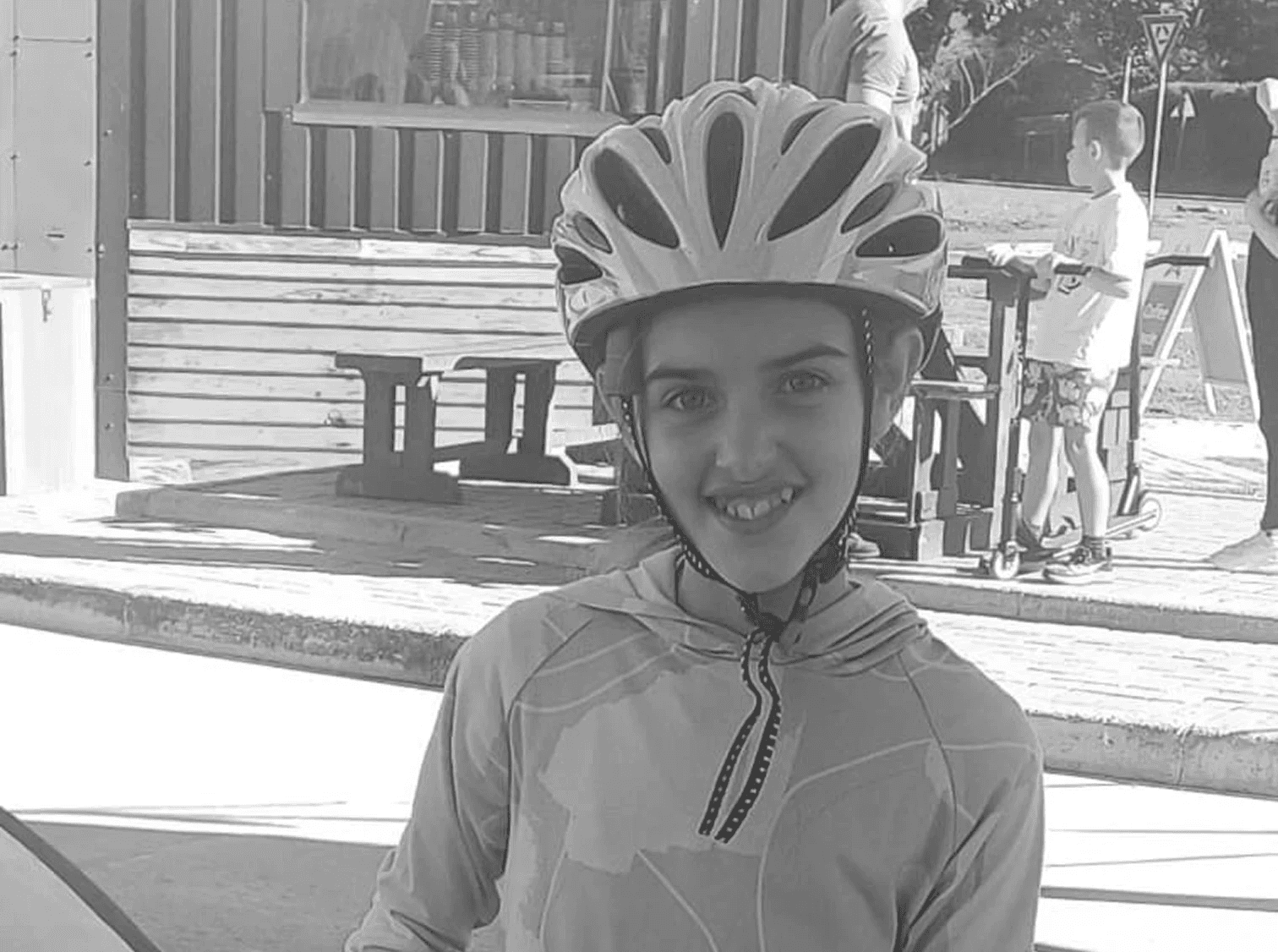 A fast black sports car races down the highway.