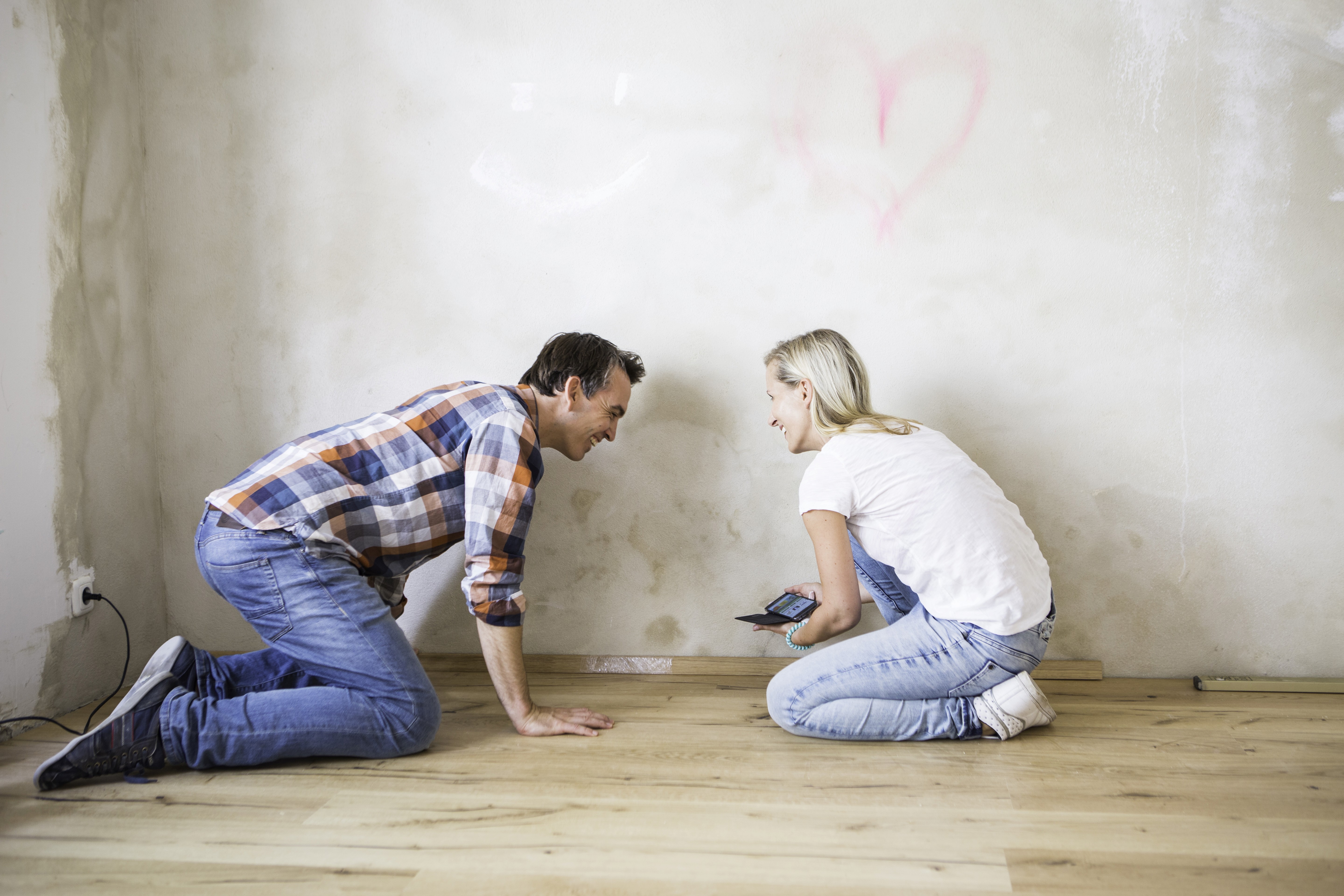 Couple planning new flooring during home renovation, choosing a durable floor solution for a smoother, stress-free finish.