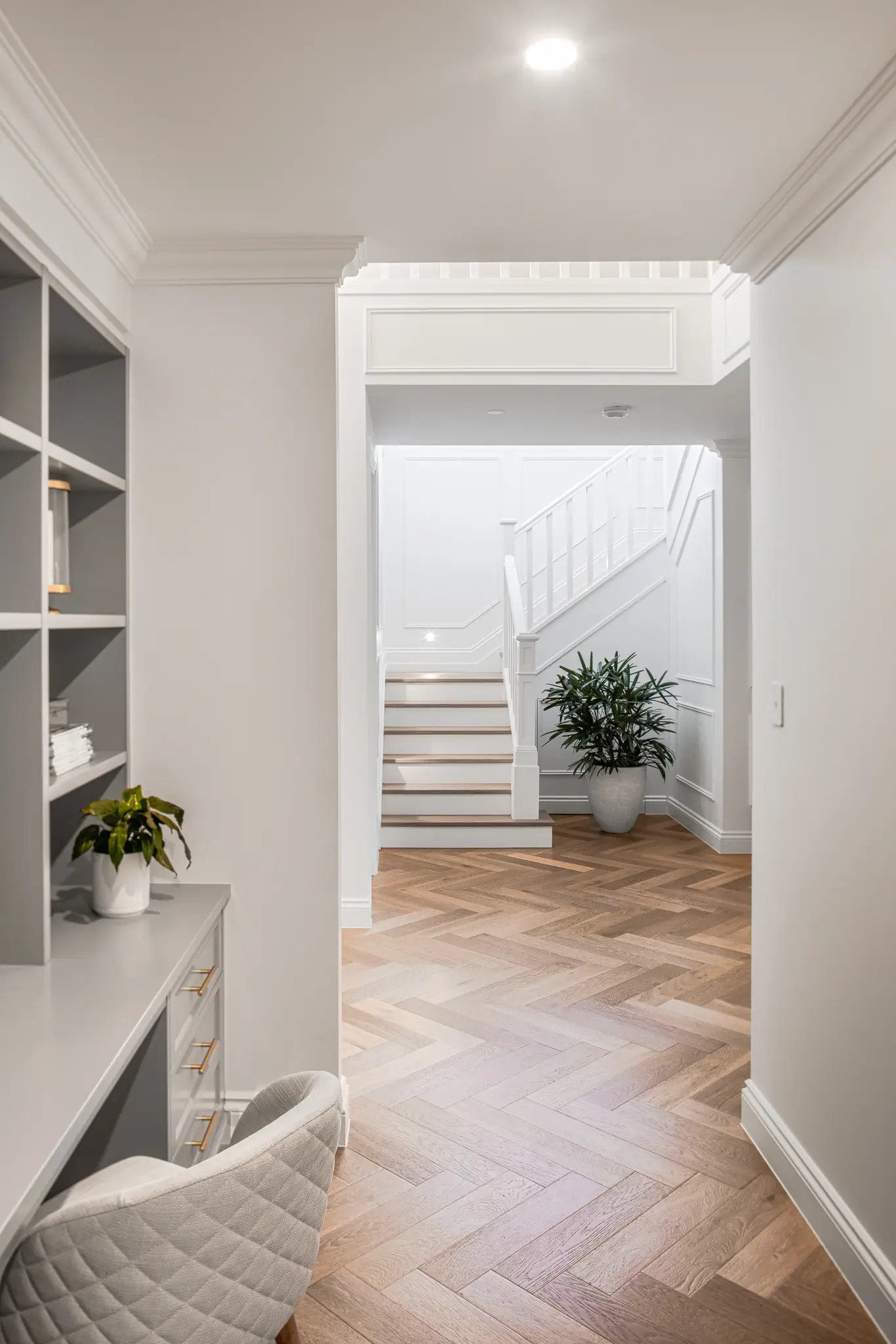 An inbuilt study area with staircase in the background in this home designed by Invilla Architecture