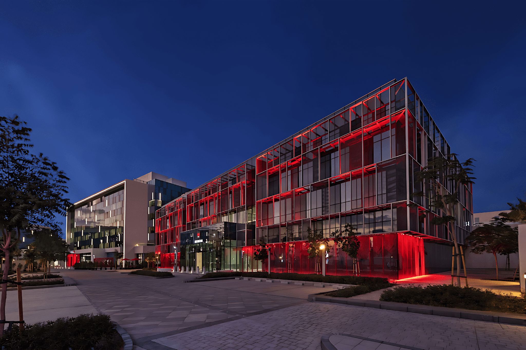 The exterior of the Radisson Red Dubai Silicon Oasis, with a contemporary design and red highlights.