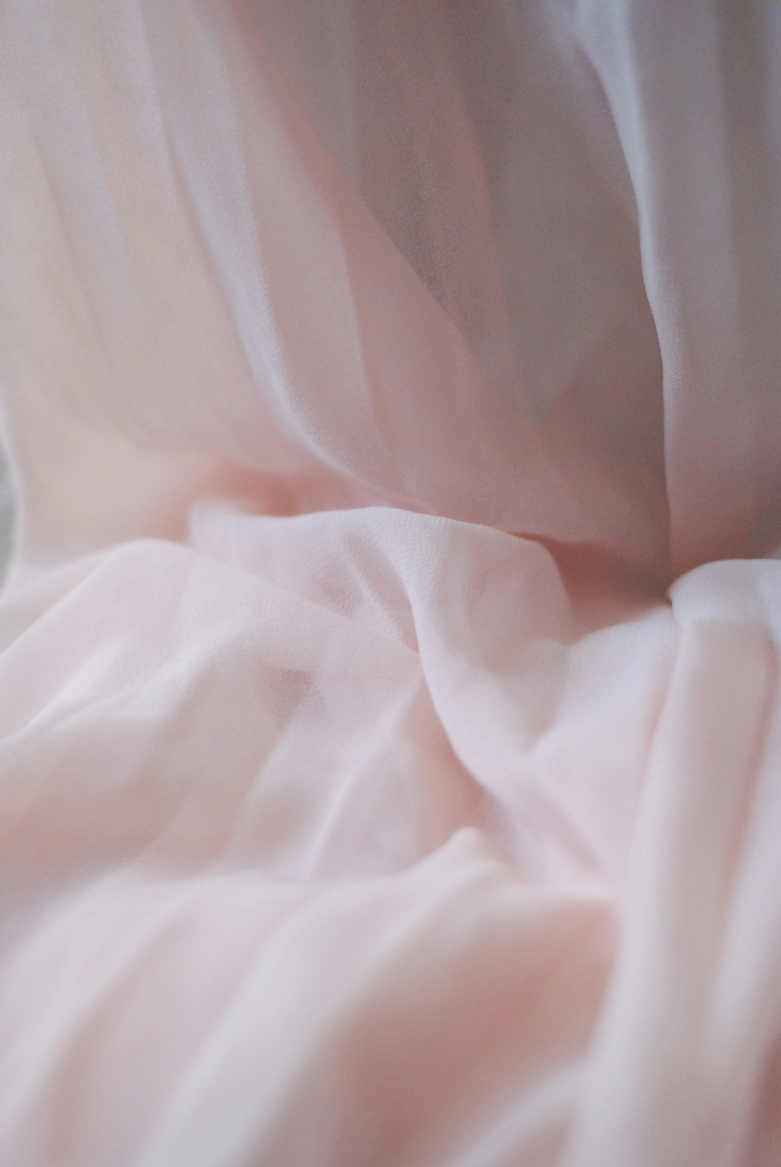 Pink organza fabric with a sheer texture