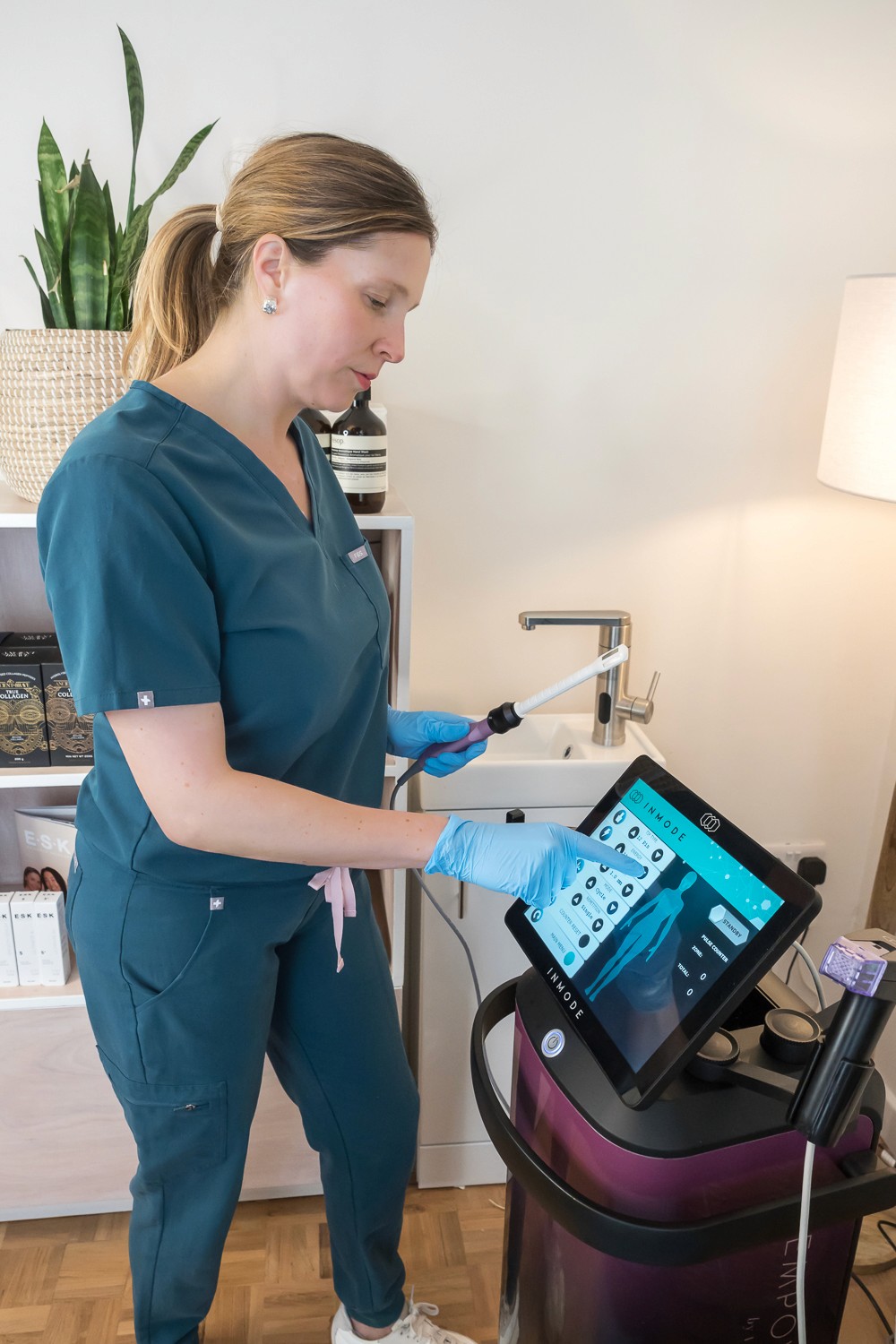 Trish Mueller, founder of Lift and Revive, preparing the InMode FormaV device for women’s intimate health treatments.