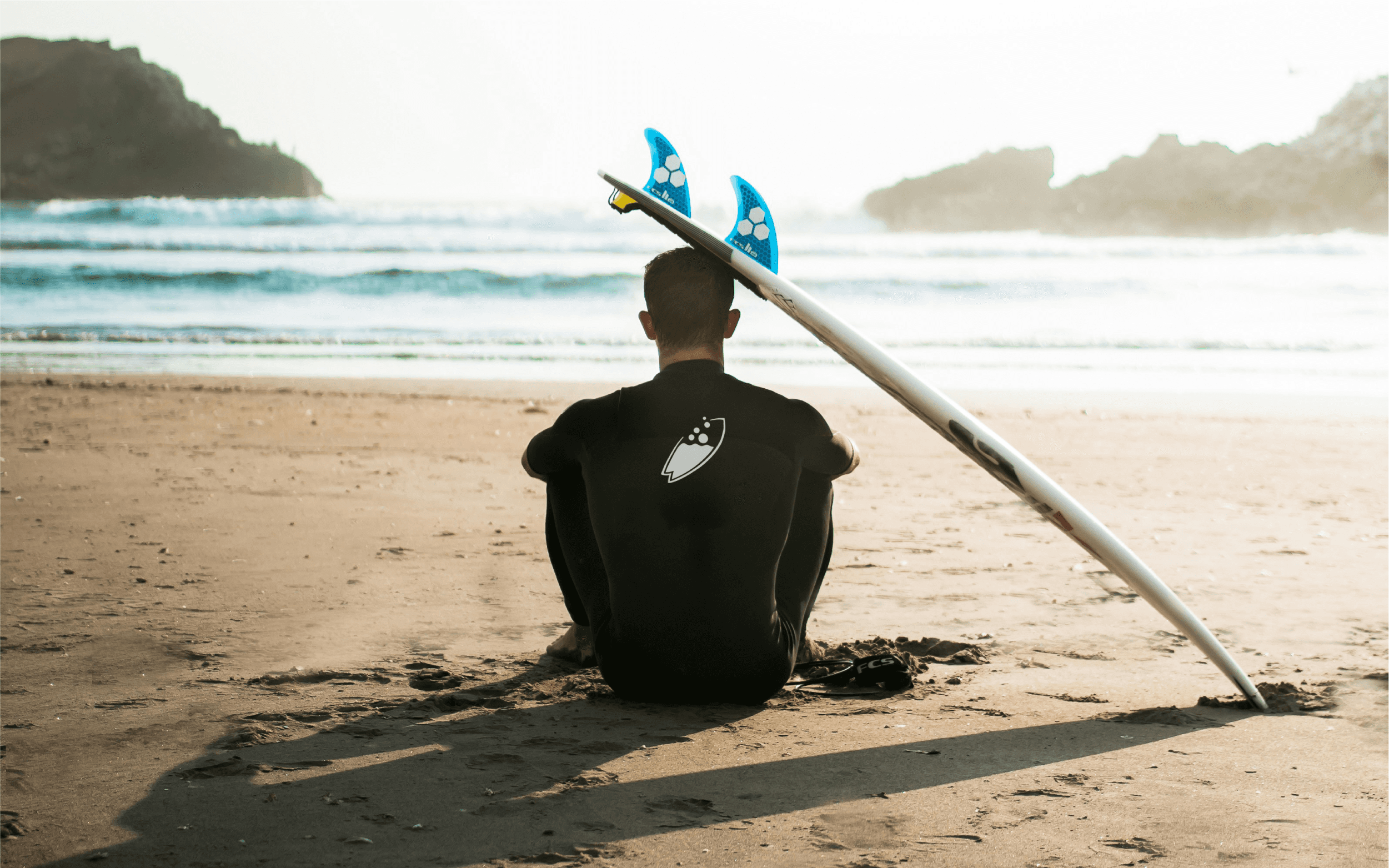 Surflab academy logo on surfer wetsuit