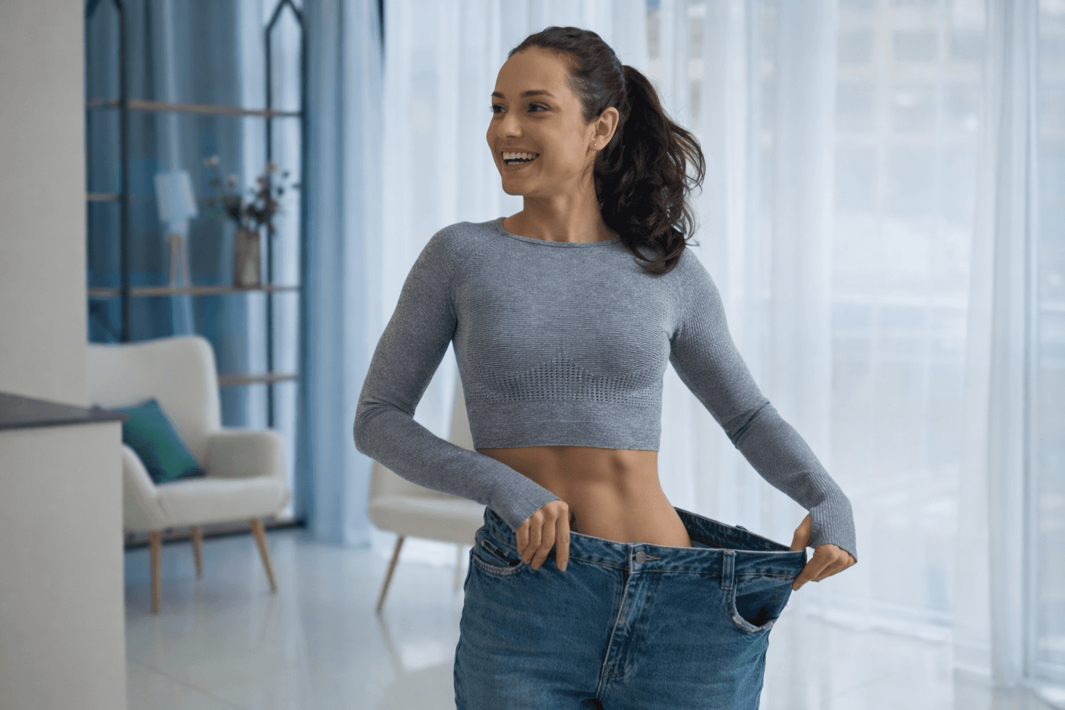 Rachel, personal trainer, looking to the side confidently in a fitness studio