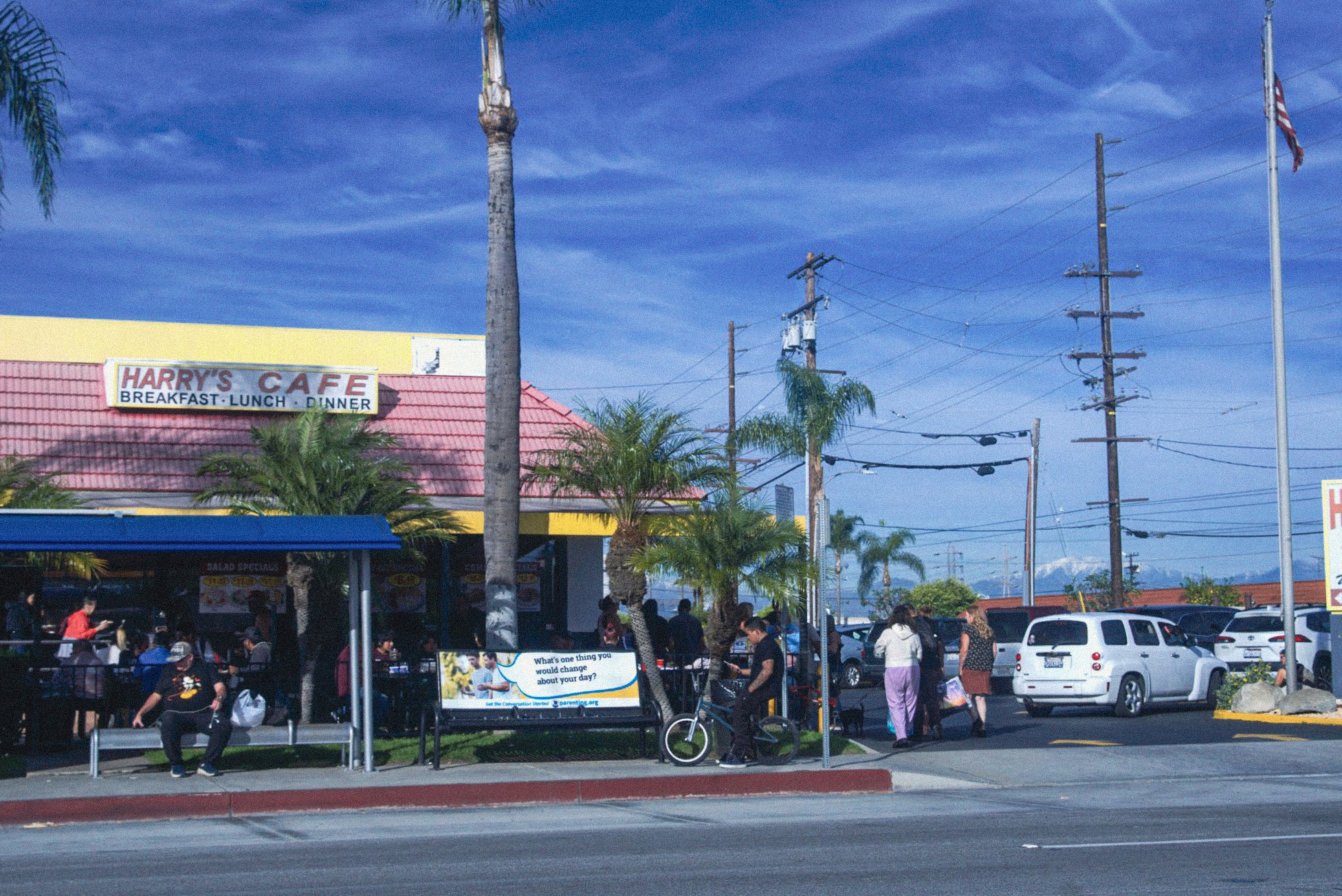 A crowd and many customers outside of brunch restaurant Harry's Cafe in Stanton located on Katella Ave