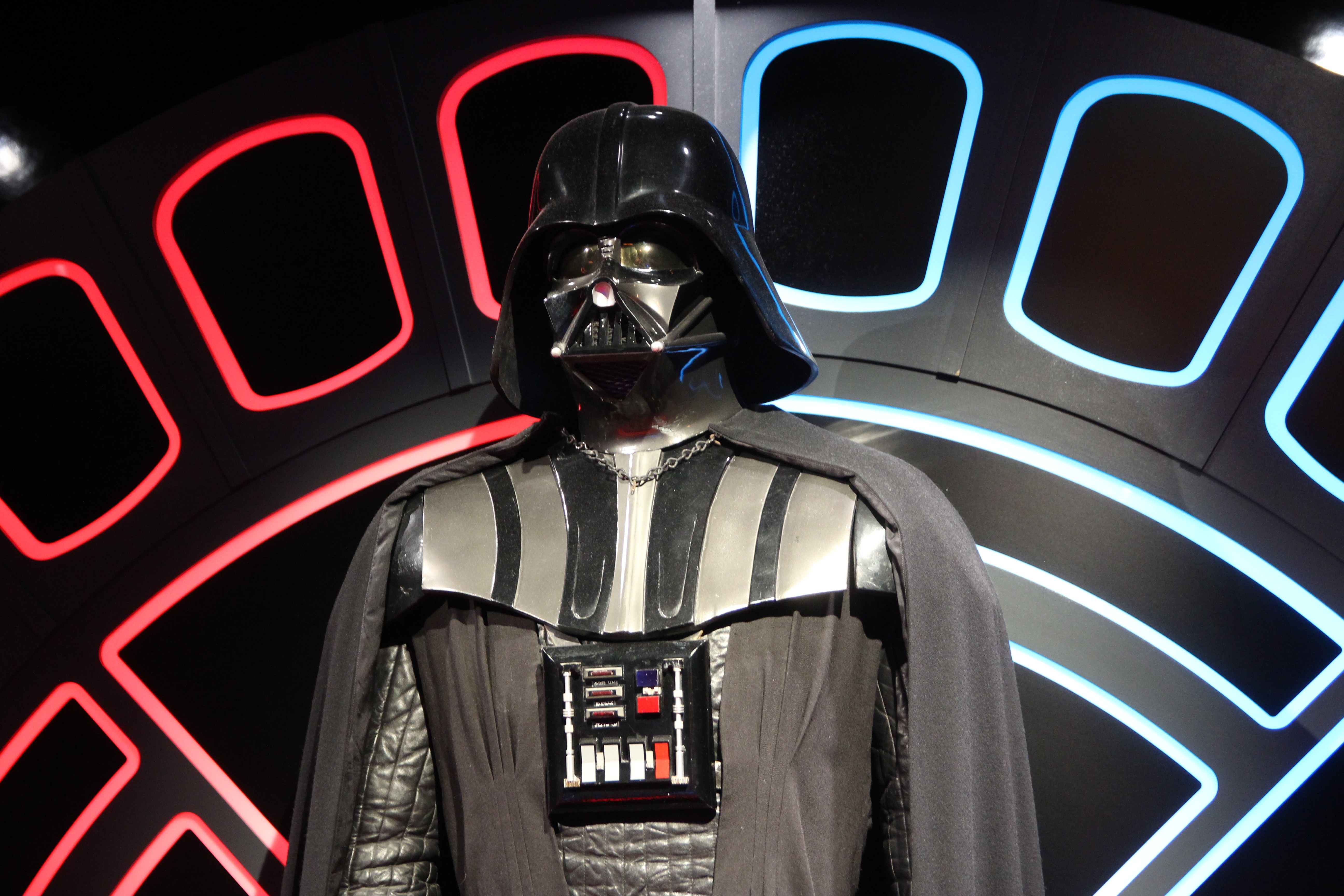 Image of Darth Vader stood against a panelled sci-fi background