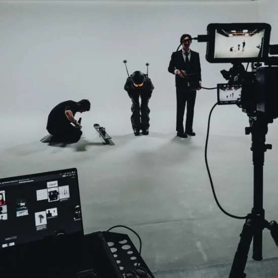 Three people in ski gear in a film studio