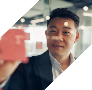 a man strategising at a glass whiteboard