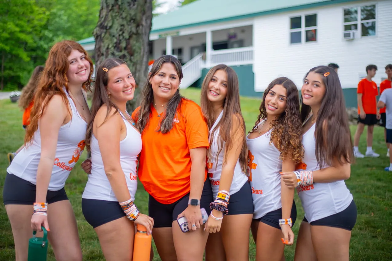 Group of campers with a counselor outside a cabin at Camp Lenox