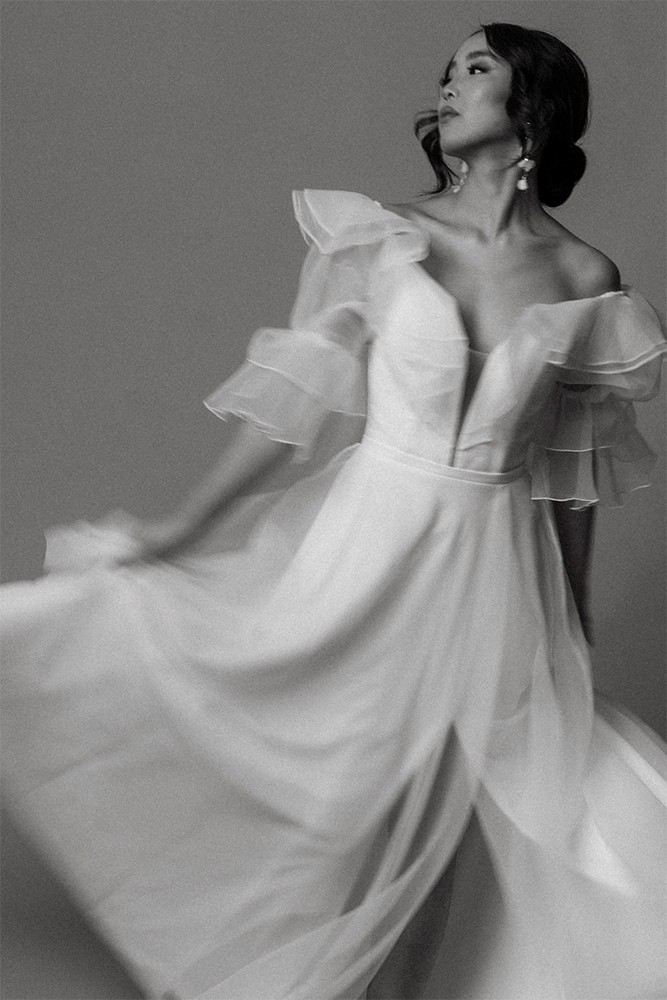 Bride with sheer fabric flowing in dramatic movement, black and white fine art bridal editorial by Eva Sitko