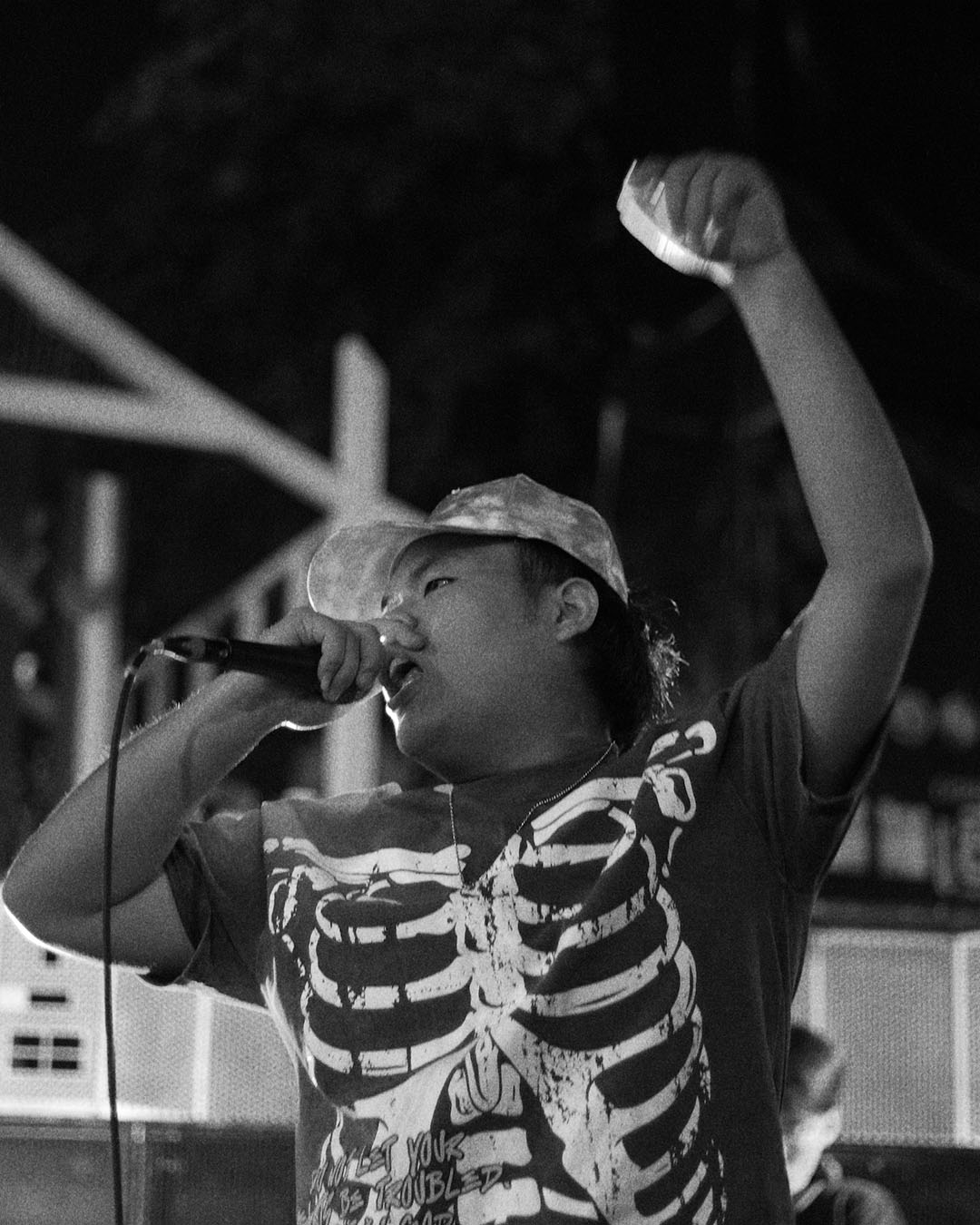 Man rapping into microphone on stage