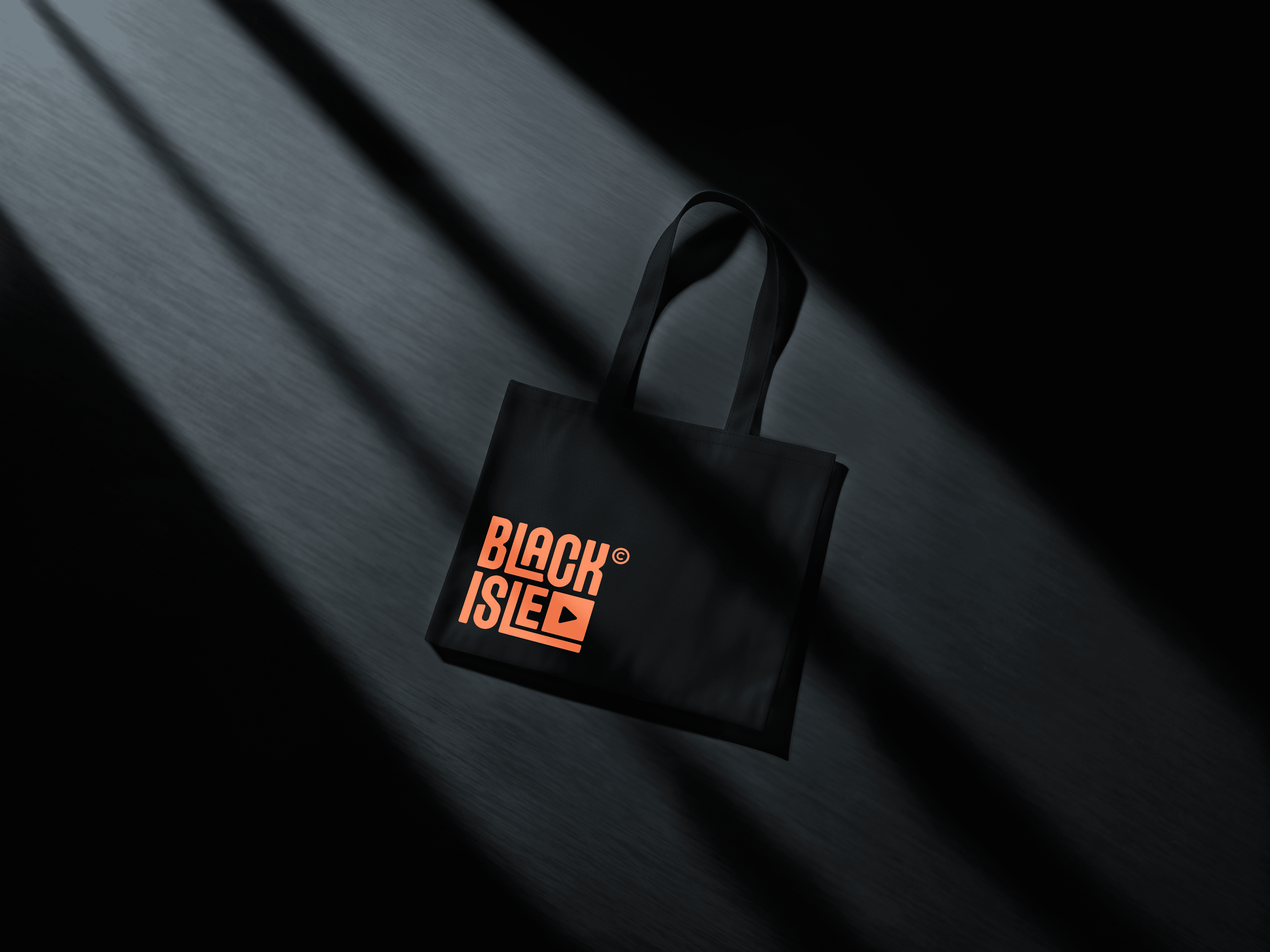 Black tote bag featuring the Black Isle Collective logo in a gradient print.