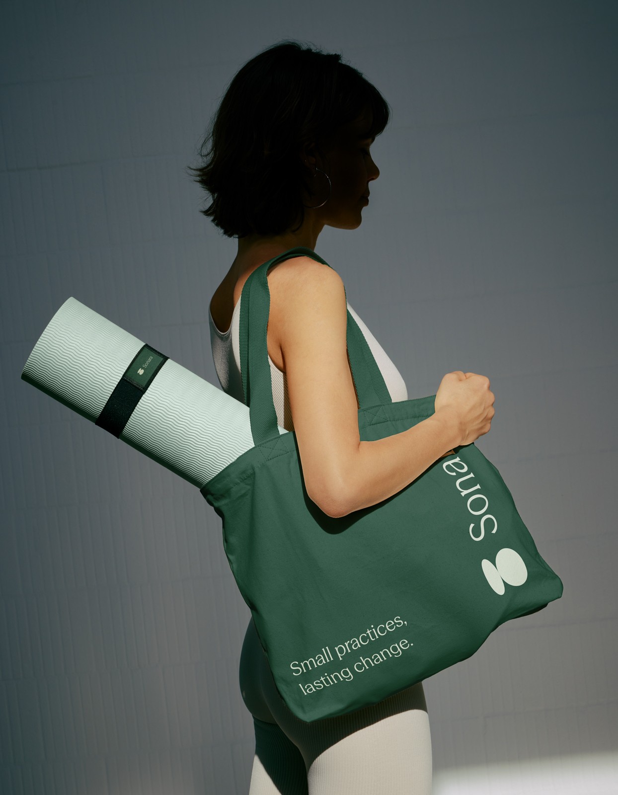 Woman with Sonara yoga mat and tote bag