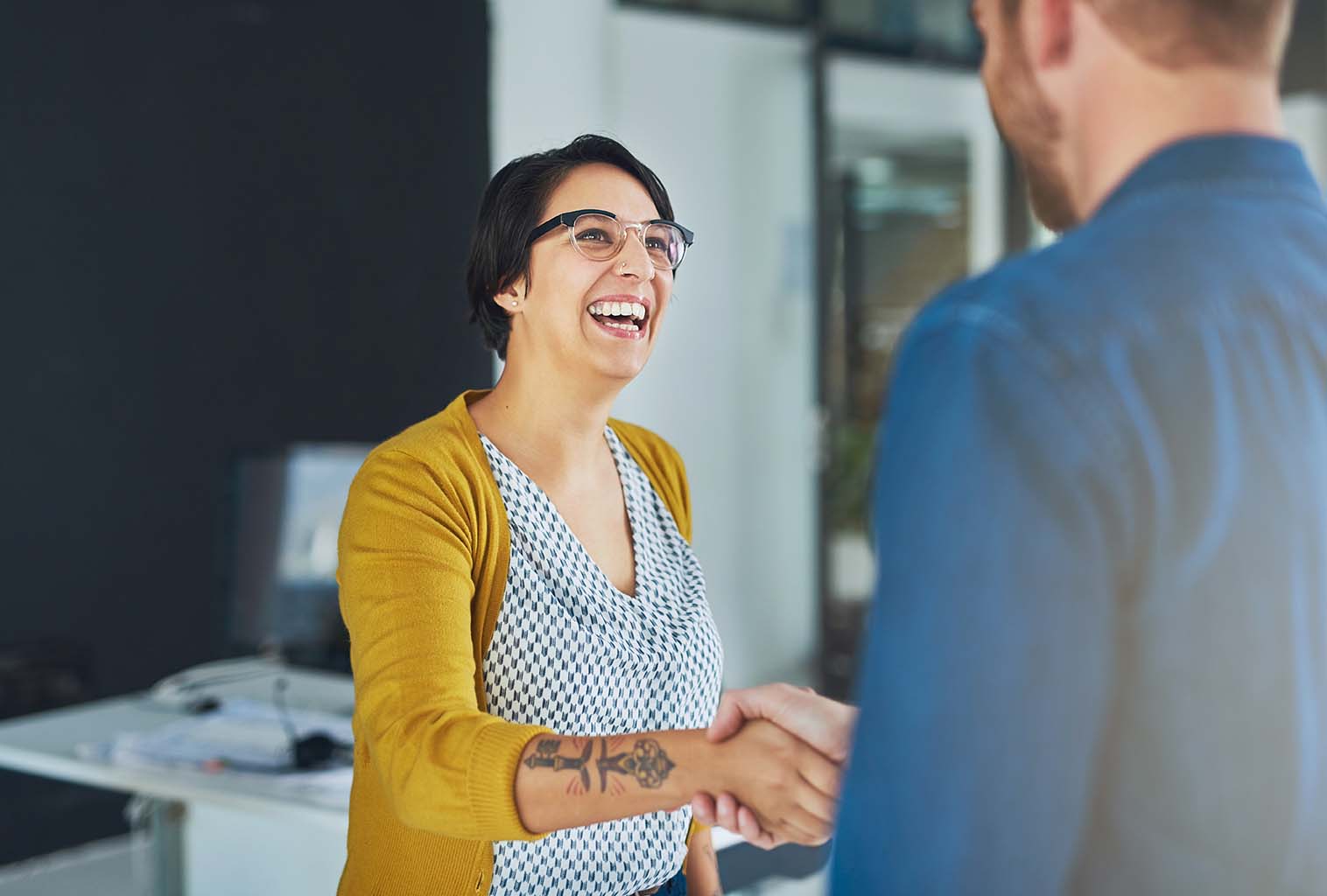 Happy smiling lady shaking hands with a man
