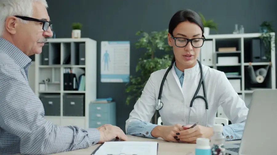 chiropractor consulting with patient in modern clinic