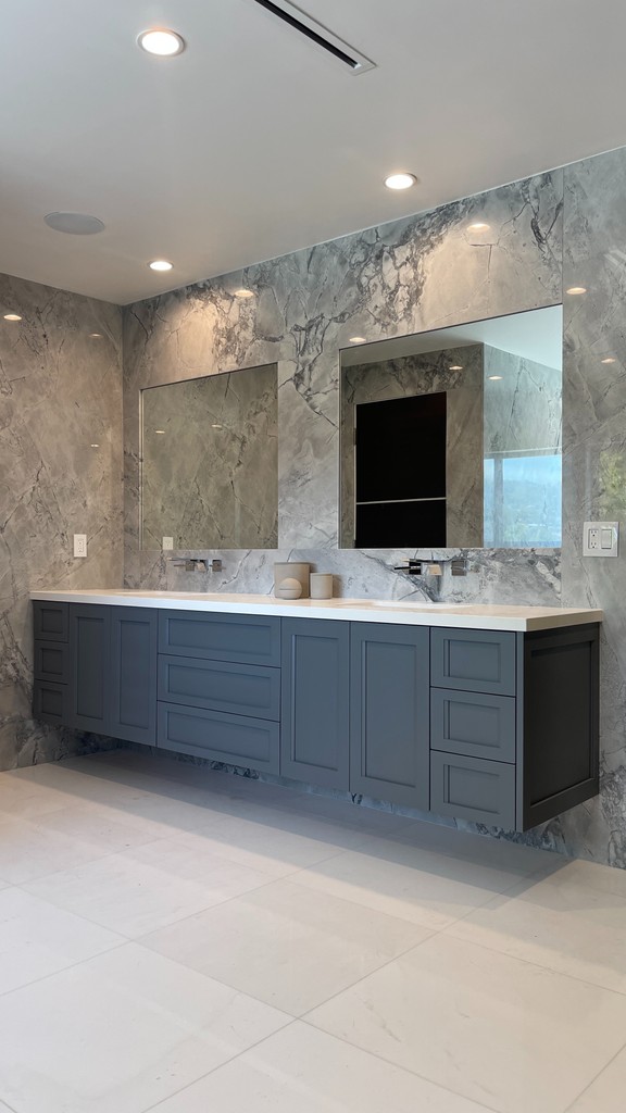 floating grey master bathroom vanity with slab walls and no handles