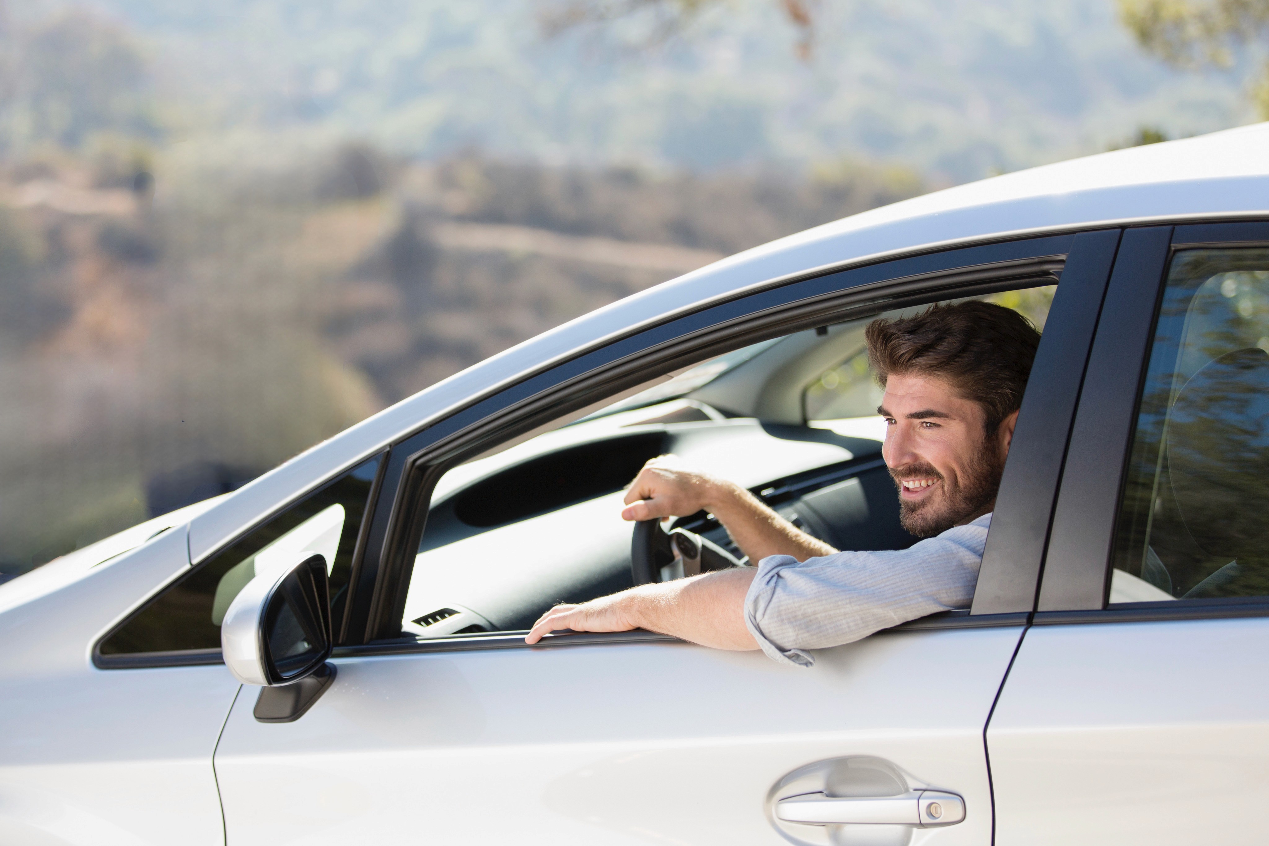 Woman smiling while driving a car