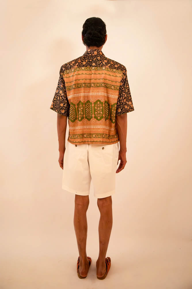 Cropped boxy silk shirt handcrafted from a vintage sari, featuring paisley print, delicate piping details, and a distinctive back panel created from the pallu, celebrating mindful craftsmanship