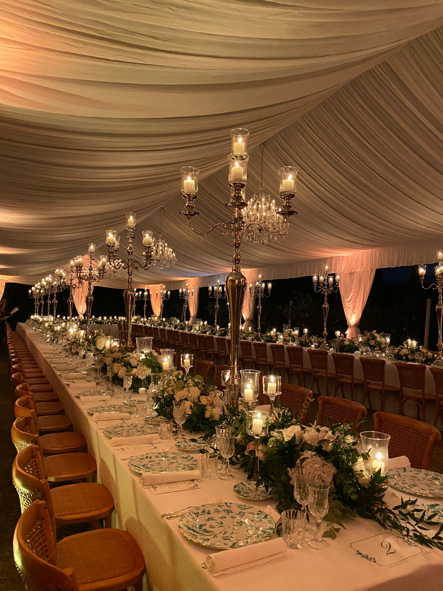 Cena di gala per matrimonio ed evento aziendale con luxury catering, lampadari, candele e allestimento elegante immerso nella natura