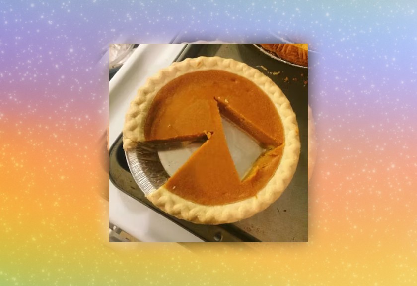Overhead photo of a half-eaten pumpkin pie on a rainbow gradient backdrop.