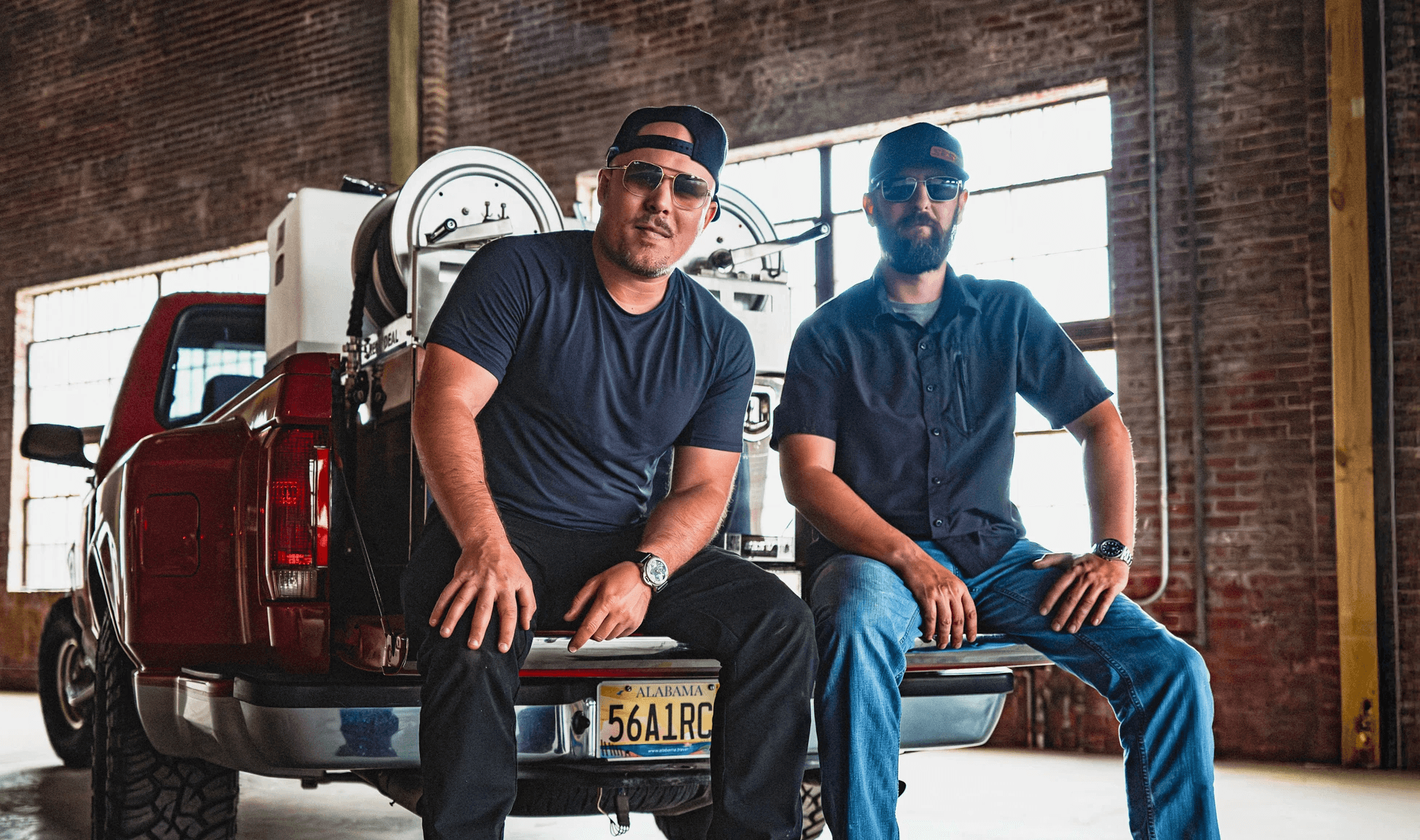 A fast black sports car races down the highway.