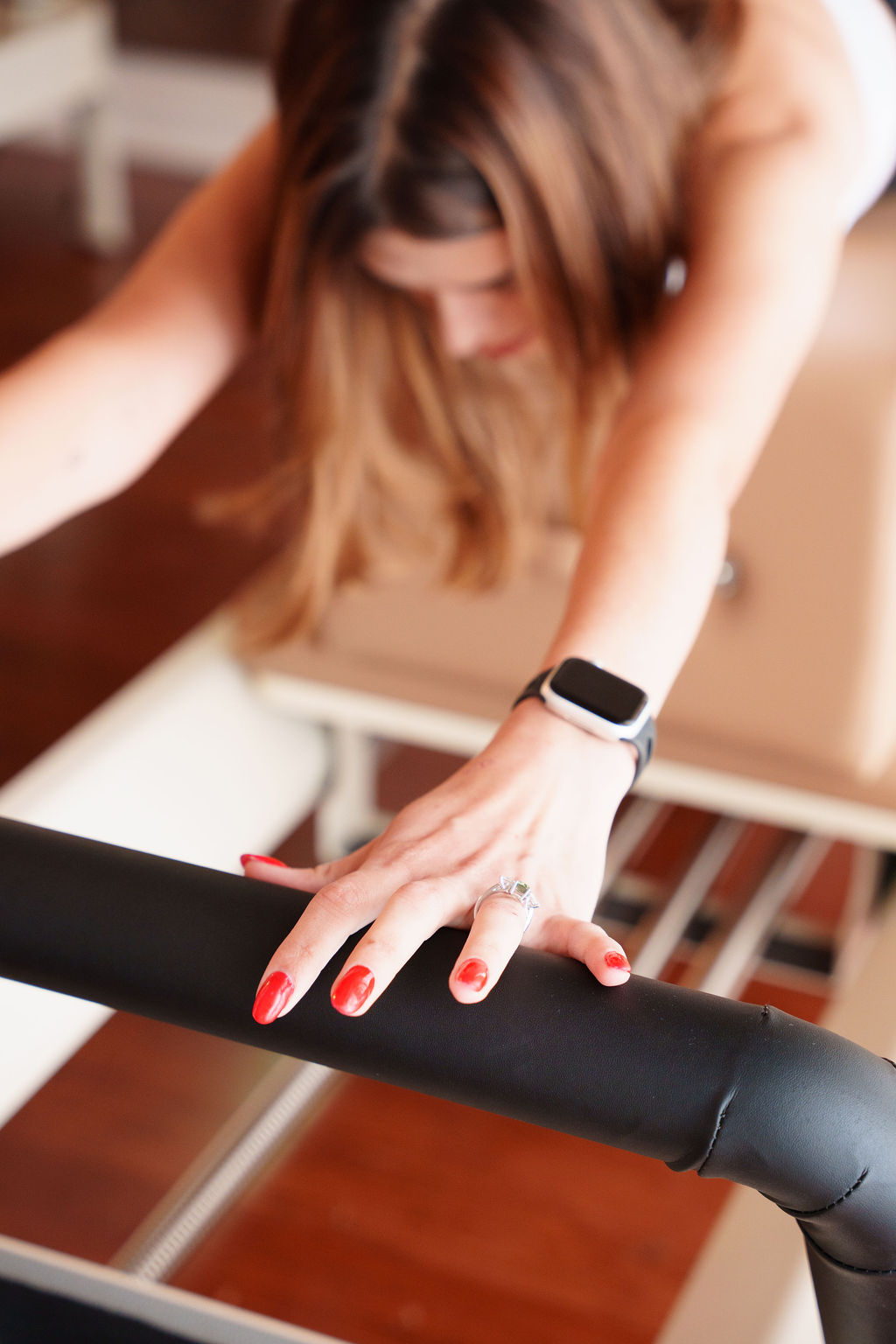 A woman balancing on a reformer in a boutique modern studio in Toronto