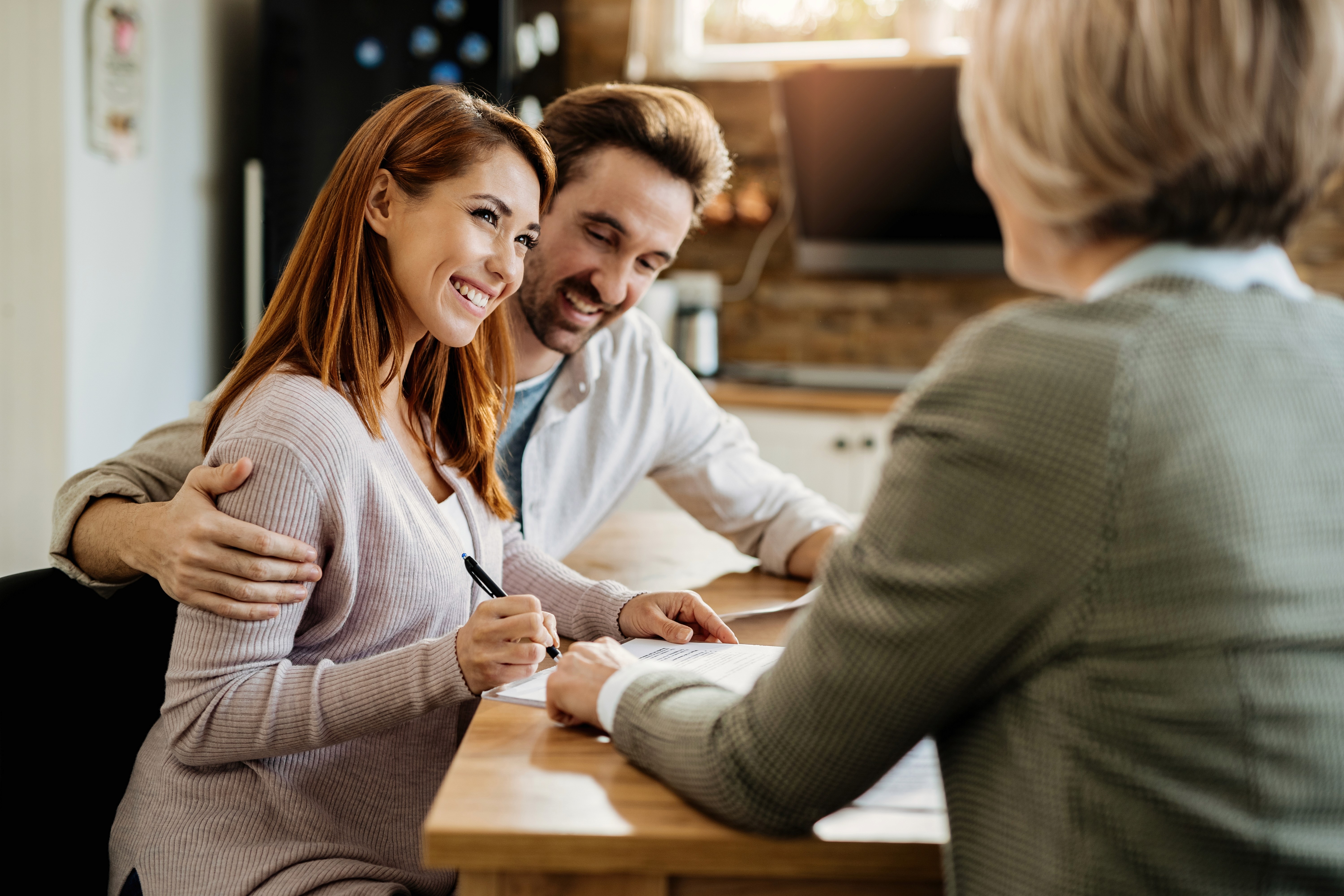 Couple and Realtor Smiling