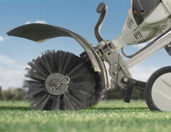 Close-up view of a STIHL MM65 Power Groomer and bristles for fluffing up AGL Grass North artificial turf.