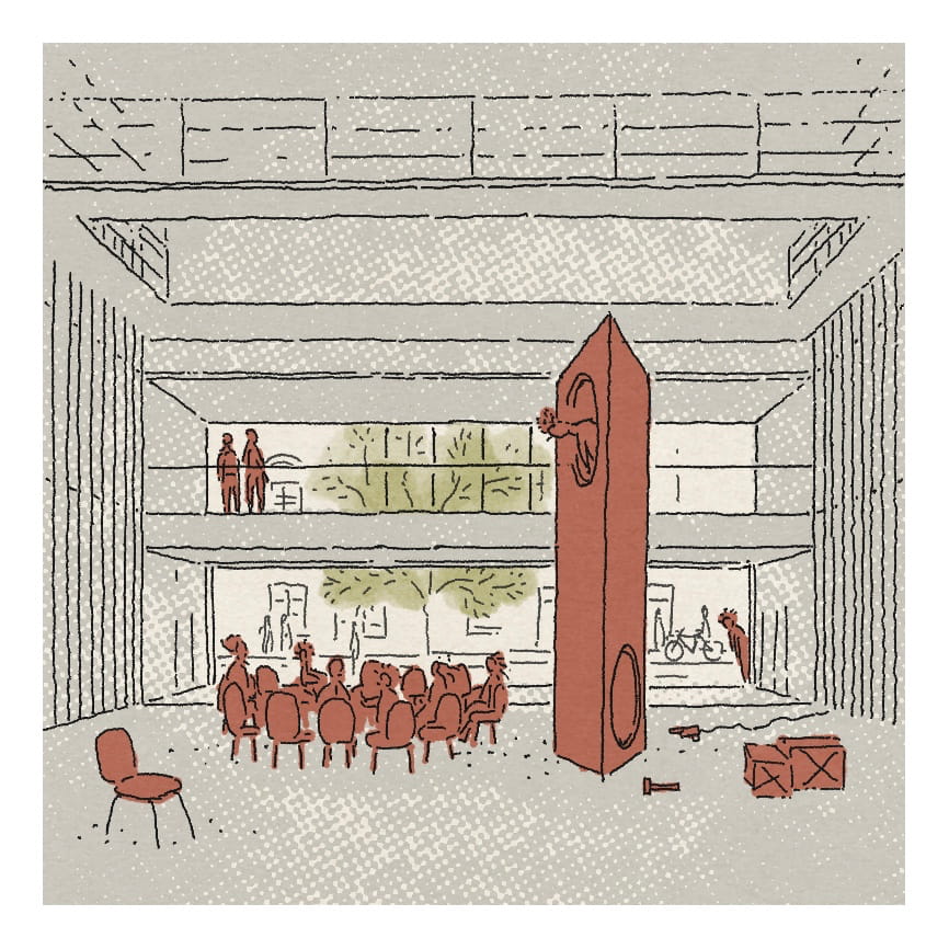 A modern interior featuring red furniture and a large geometric sculpture, with large windows and greenery visible.