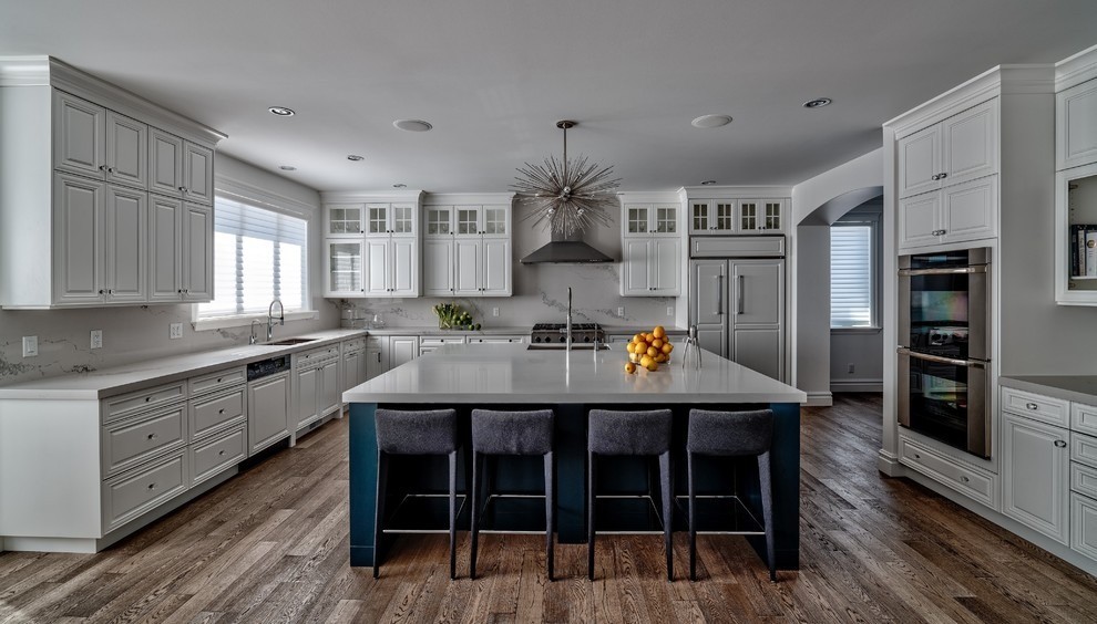 Image of Luxury kitchen design by KHD Homes featuring a large island, marble counters, and modern furniture.