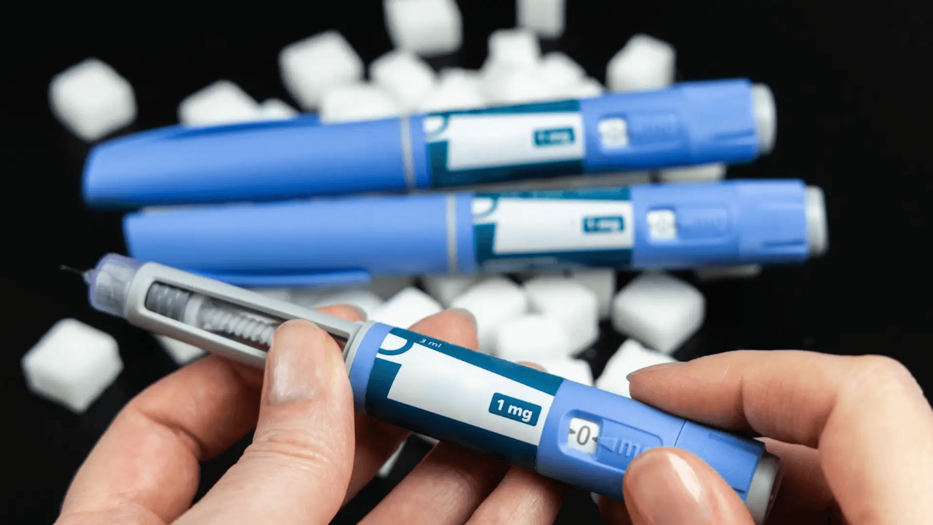 Person holding blue injectable medication pen - Semaglutide for Weight Loss in Non-Diabetics Dosage