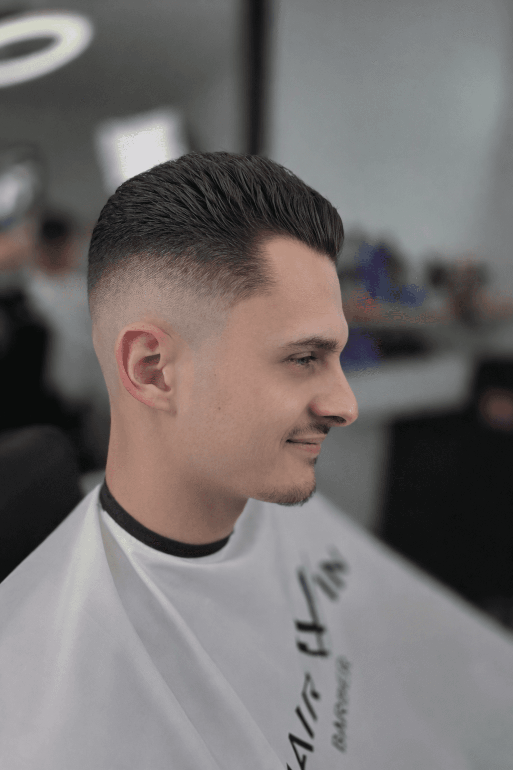 a man getting his hair cut by a barber