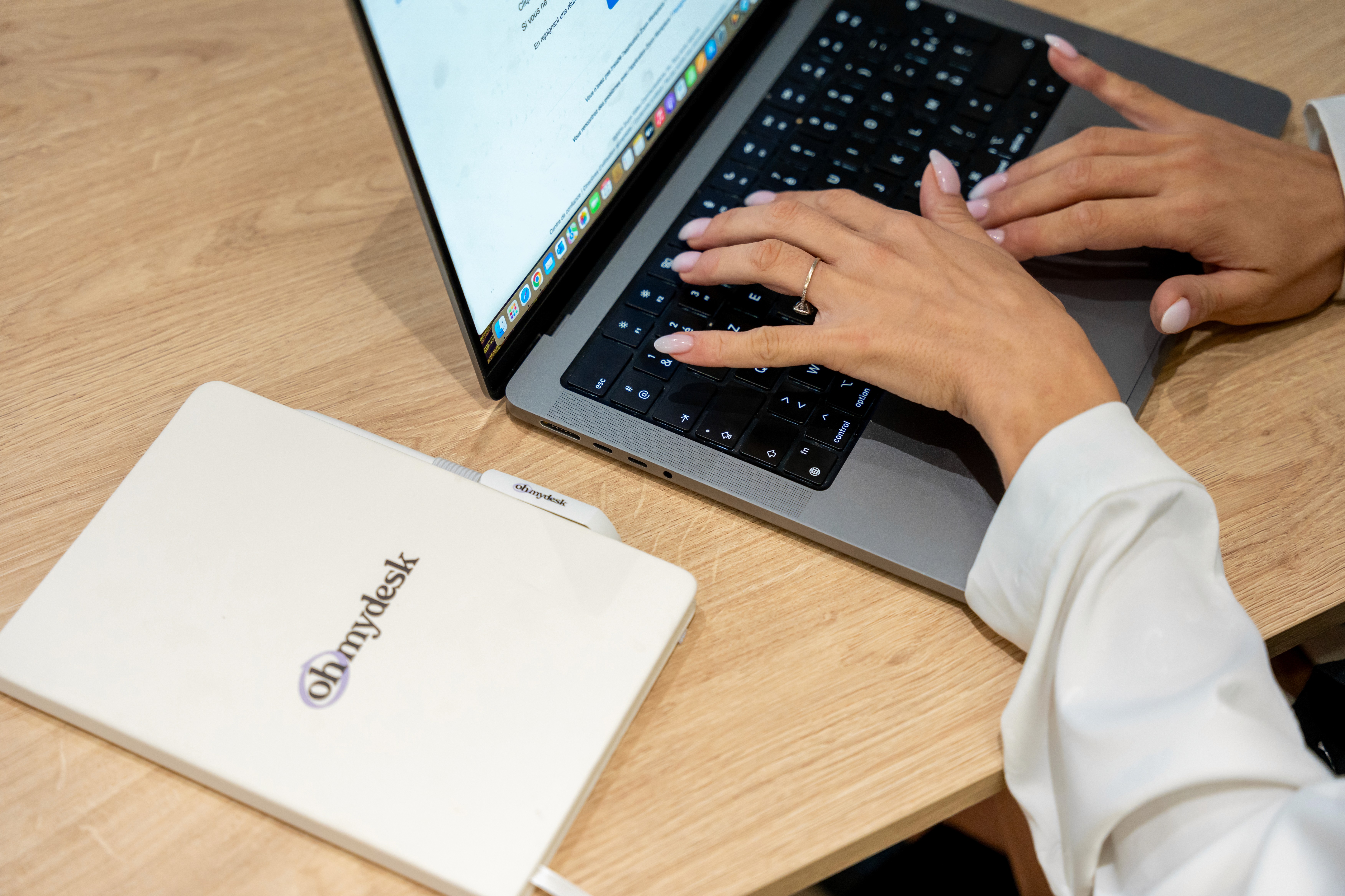 Business professional working on a laptop in a private office in Dubai, with a stylish workspace setup.