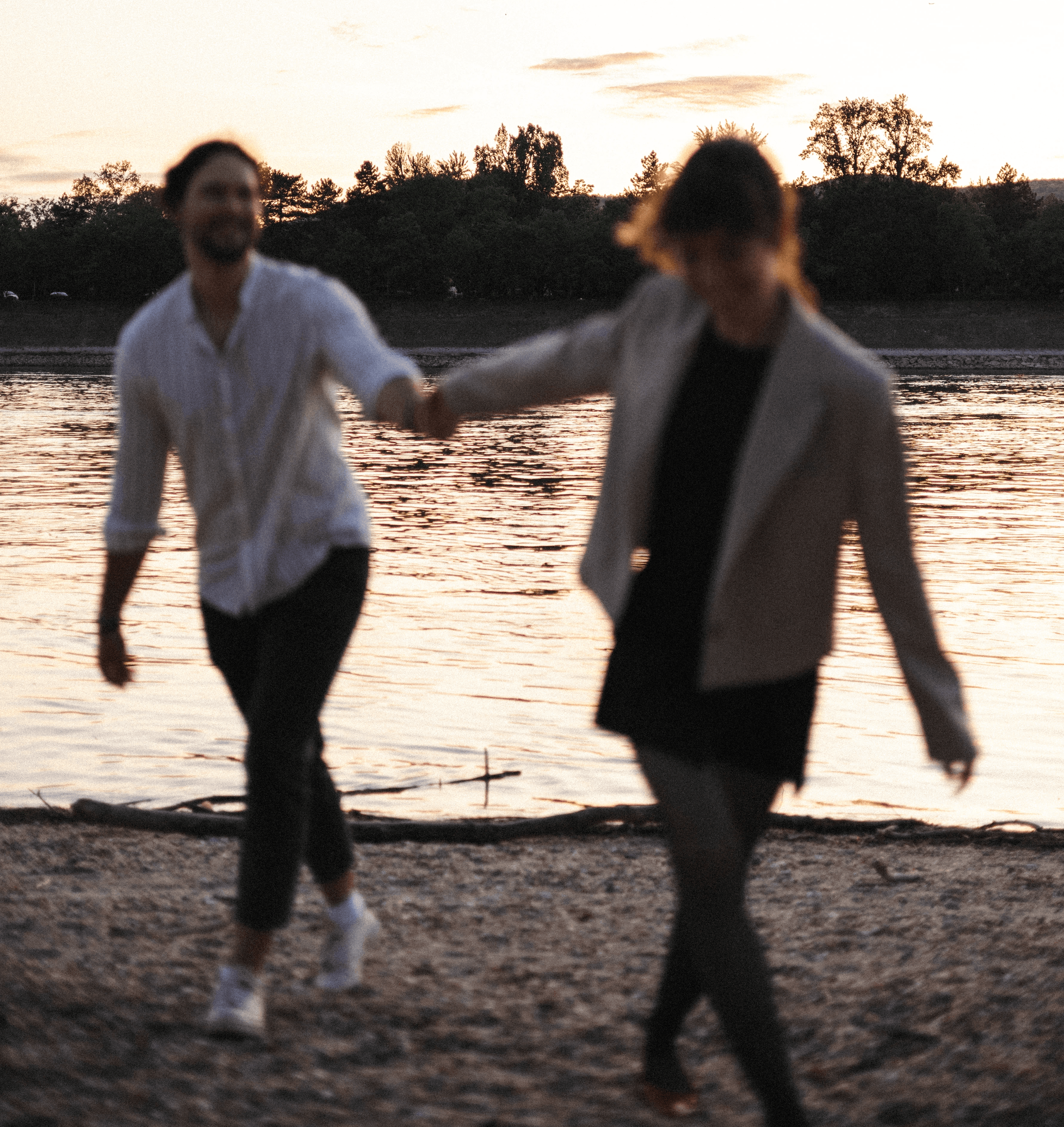 A woman laughing and connecting in nature during a mindfulness retreat, soft golden hour light, natural landscape, relaxed clothing