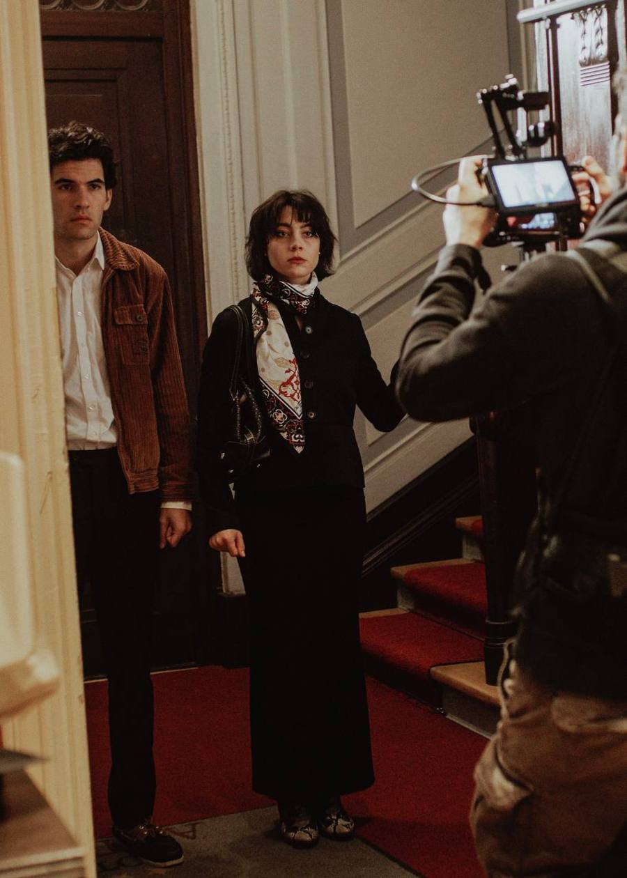 Two actors on the stairs with the camera operator
