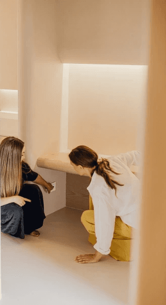 Woman shows another woman panic button in cabin