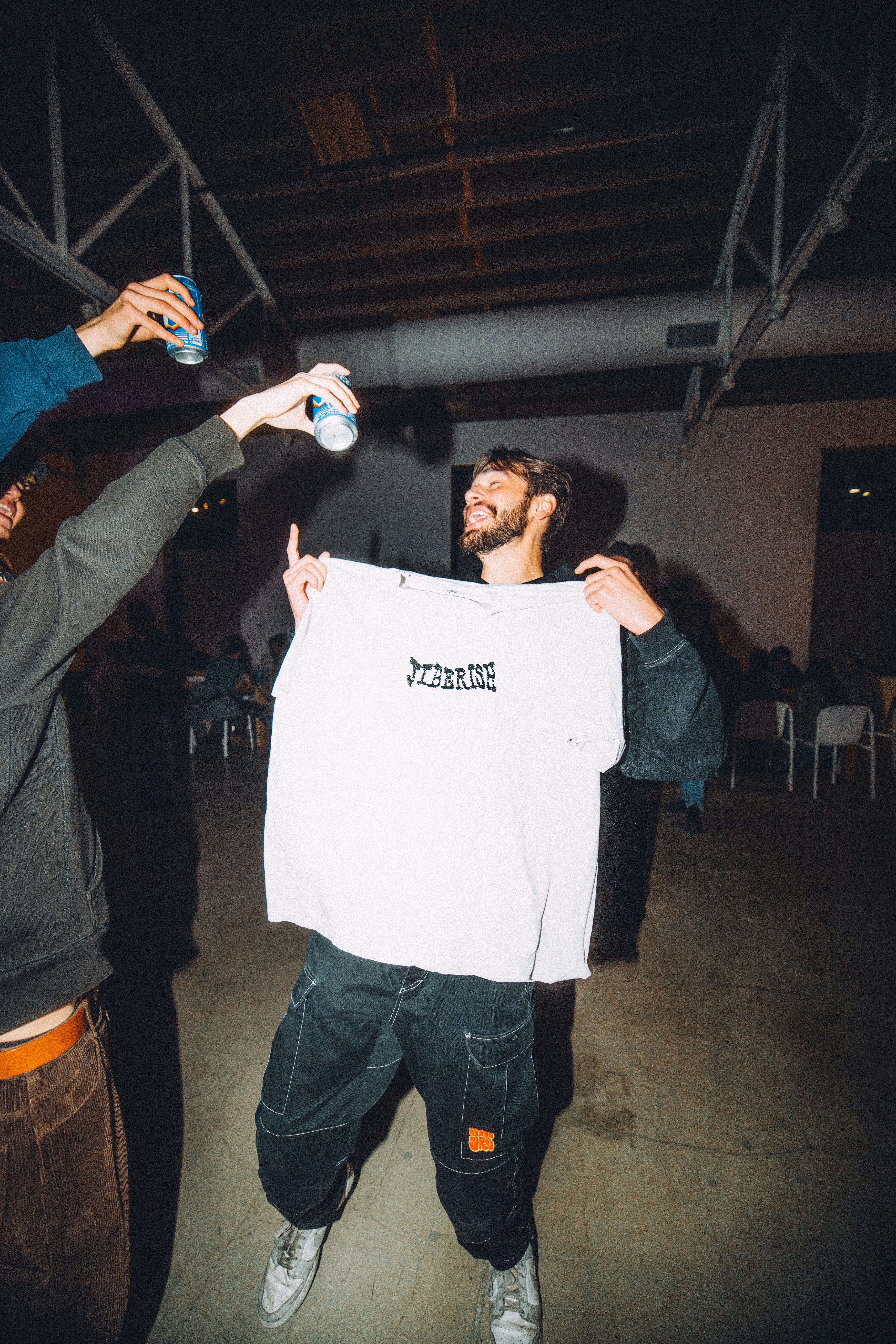 man holding merchandise t-shirt