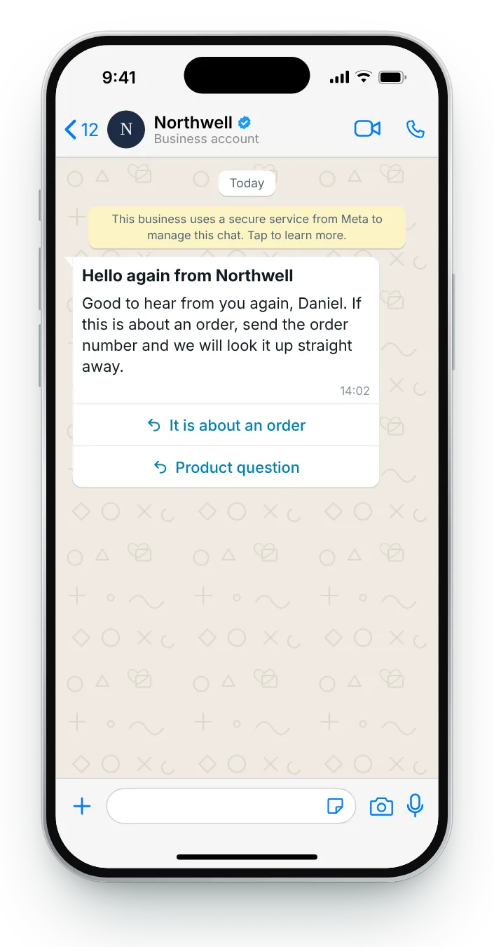 Greeting a customer after a quiet spell: WhatsApp greeting message on an iPhone