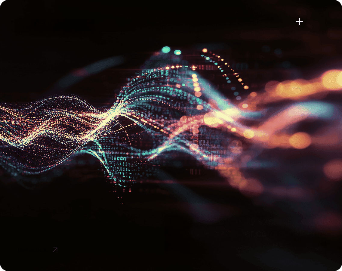 Four diverse professionals collaboratively working on a laptop, with one person pointing at the screen while others observe.