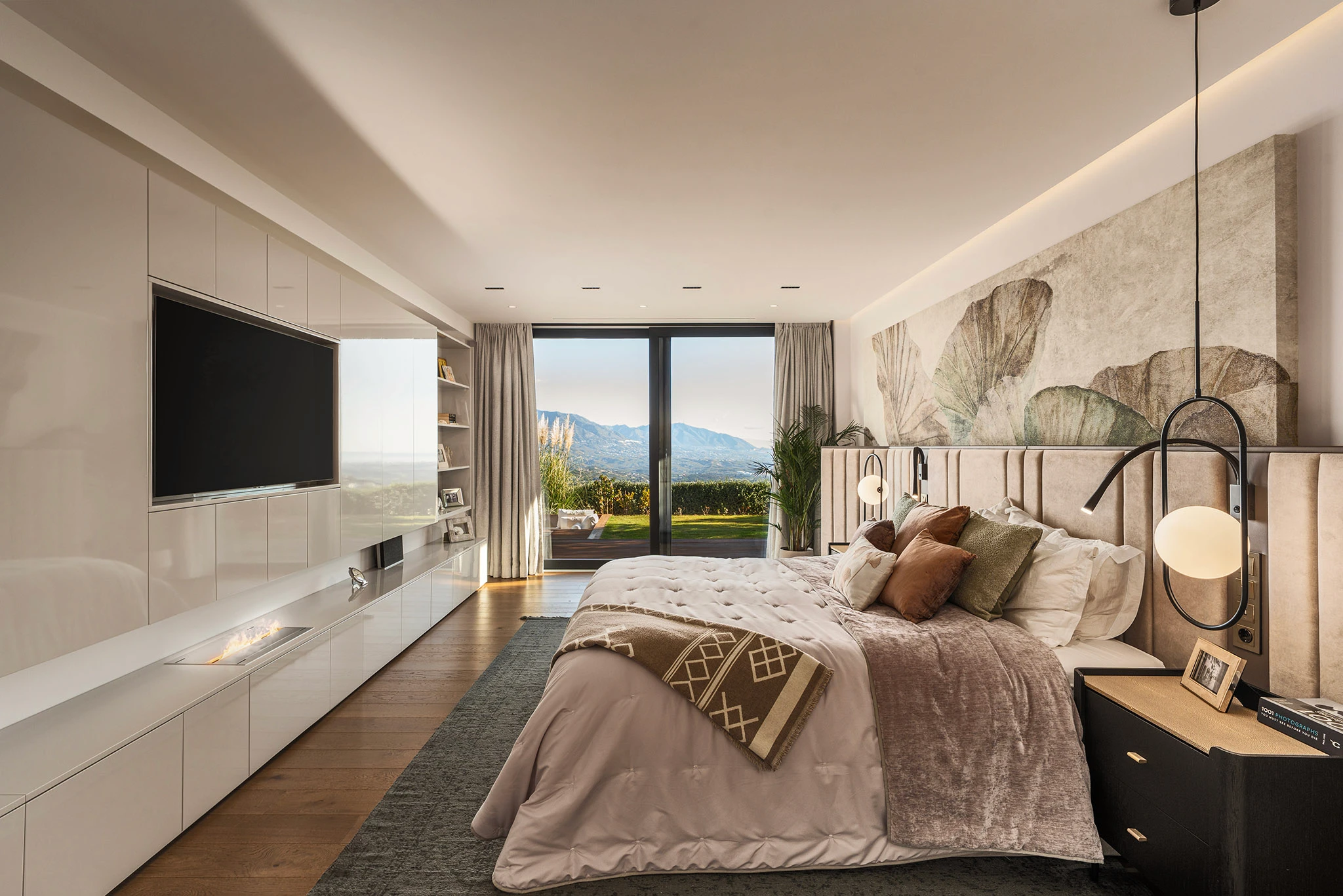 Villa Vista Marbella master bedroom with custom wall mural, built-in cabinetry, and mountain-view glazing