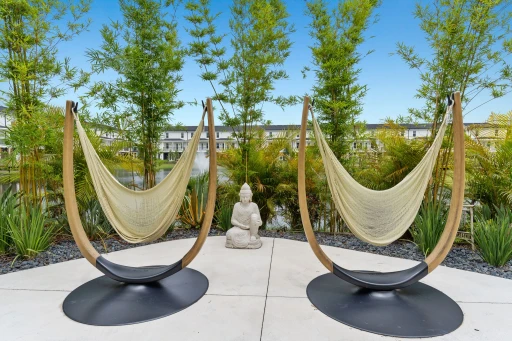 A patio features two hammocks, creating a cozy space for leisure and enjoyment in the fresh air.