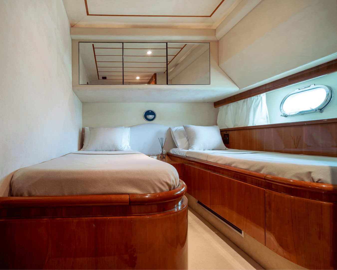 White Rock 36 speedboat with captain at helm cruising calm blue waters near Paros coastline with hills in background.