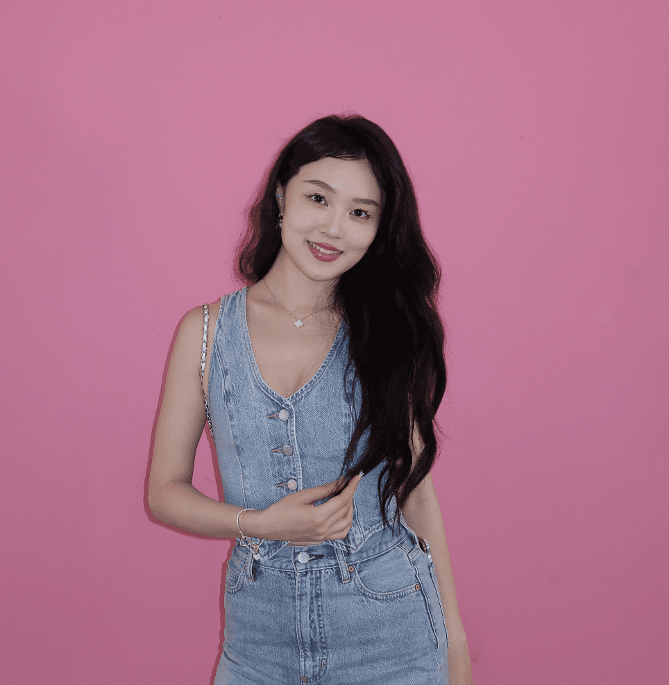 A thoughtful young person with dark hair gazes to the side, captured in soft black and white lighting.