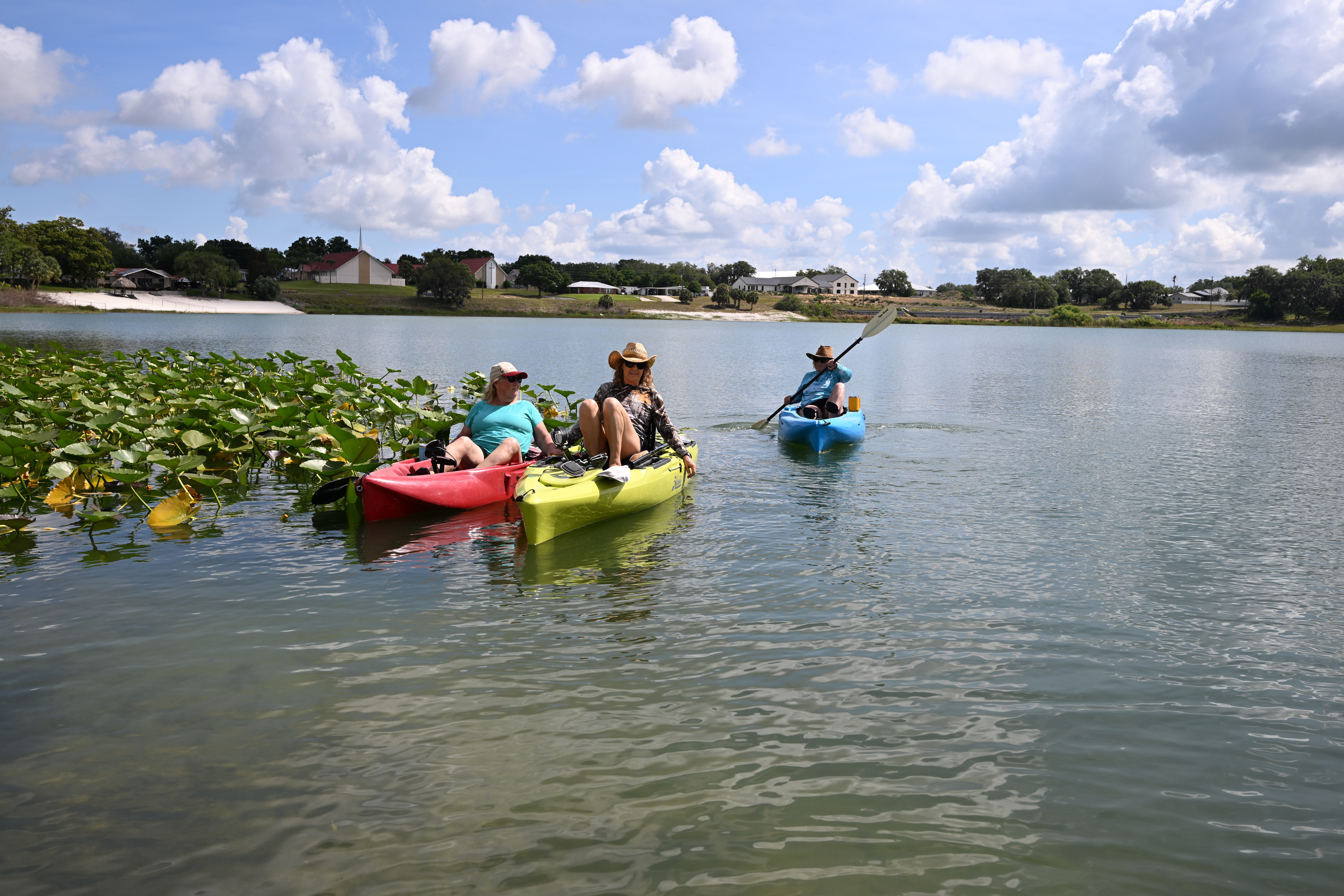 A group of female kayakers on a lake