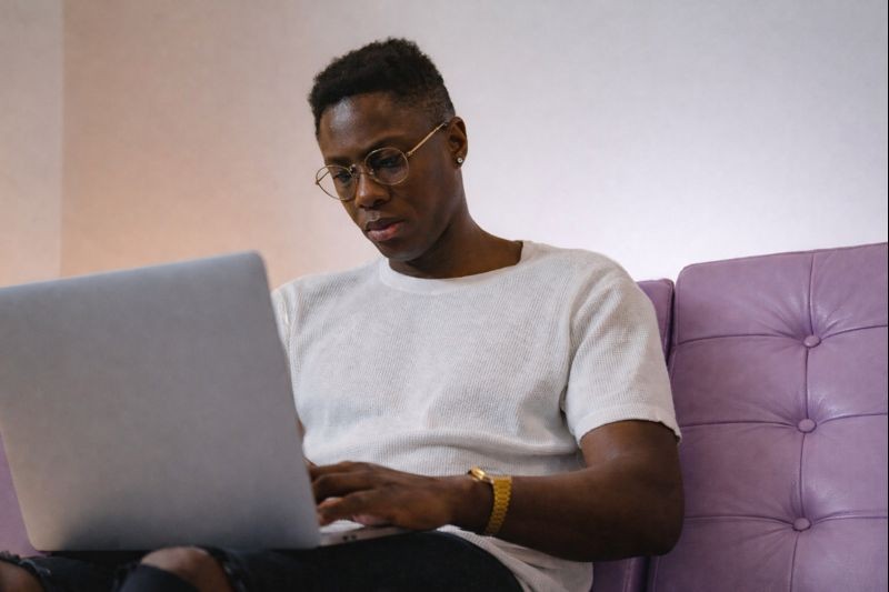 Couple reviewing documents together on laptop at home